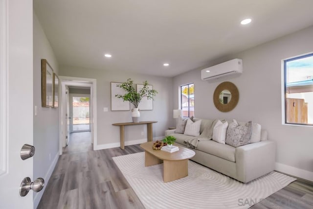 living room featuring a wall mounted AC and light wood-type flooring