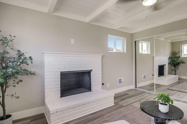 living room featuring wood ceiling, beamed ceiling, a fireplace, and wood-type flooring