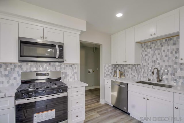 kitchen with white cabinetry and appliances with stainless steel finishes