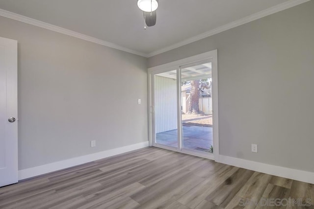 empty room featuring crown molding and light hardwood / wood-style floors