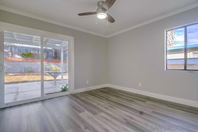 unfurnished room featuring hardwood / wood-style flooring, crown molding, and ceiling fan