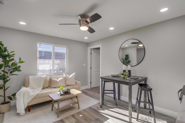 living room featuring ceiling fan and light wood-type flooring