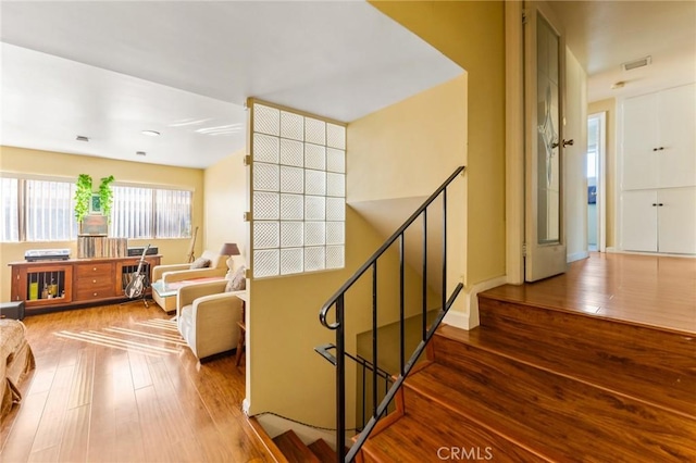 staircase featuring hardwood / wood-style floors