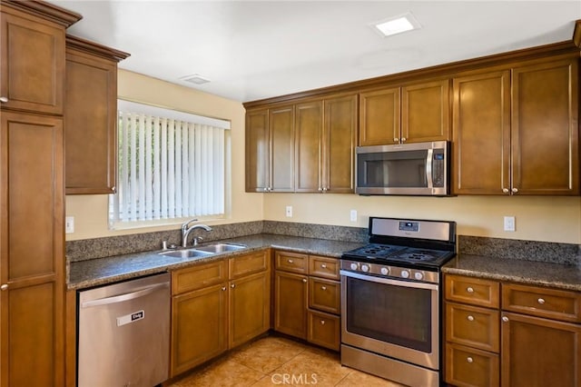 kitchen featuring sink, light tile patterned floors, and stainless steel appliances