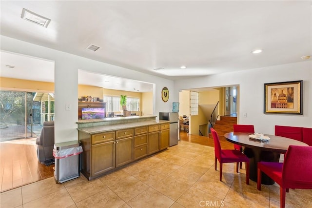 kitchen featuring a wealth of natural light and light tile patterned floors