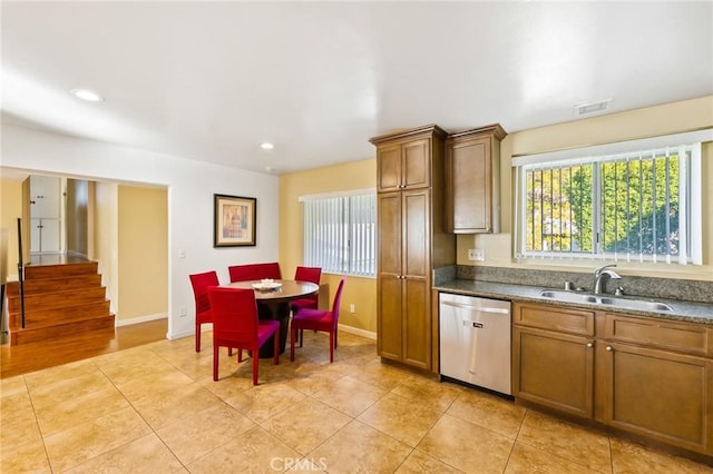 kitchen featuring sink, light tile patterned floors, and stainless steel dishwasher