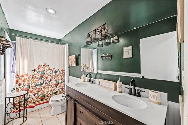 full bathroom with shower / bath combo, tile patterned floors, vanity, and toilet