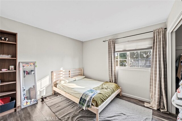 bedroom with hardwood / wood-style floors