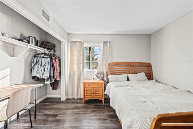 bedroom featuring dark wood-type flooring