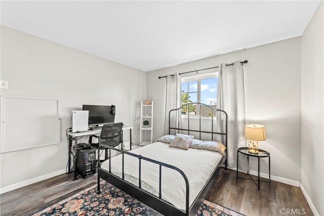 bedroom featuring dark hardwood / wood-style flooring