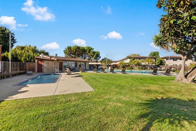 view of pool with a lawn and a patio area