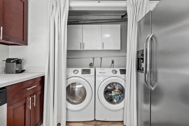 laundry room with cabinets and washing machine and dryer