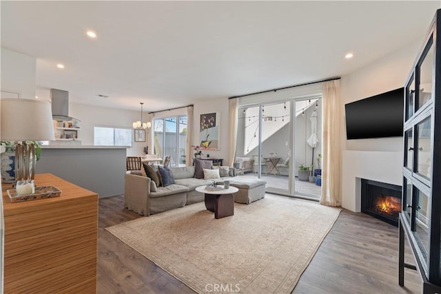 living room with hardwood / wood-style flooring and an inviting chandelier