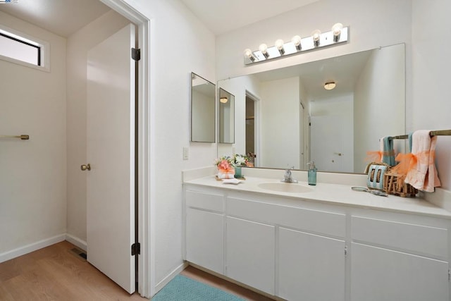 bathroom with vanity and wood-type flooring