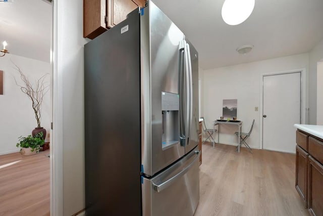 kitchen featuring stainless steel fridge and light wood-type flooring