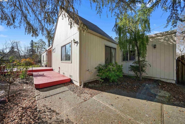 view of home's exterior featuring a wooden deck