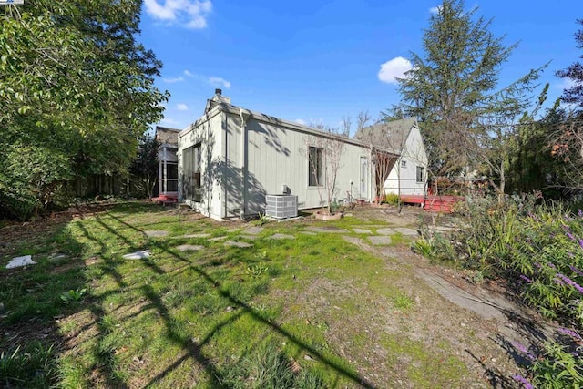 exterior space featuring a yard and central air condition unit