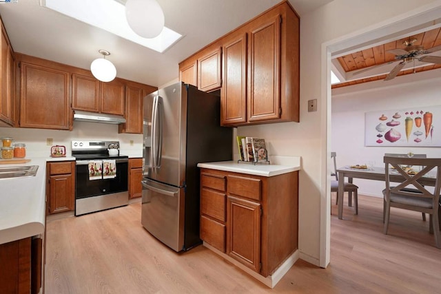 kitchen featuring ceiling fan, appliances with stainless steel finishes, light hardwood / wood-style floors, and a skylight