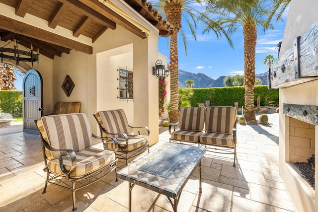 view of patio / terrace with a mountain view and an outdoor hangout area