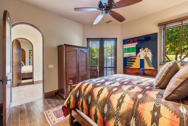 bedroom featuring ceiling fan, hardwood / wood-style floors, and french doors