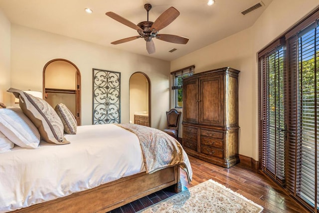 bedroom with a closet, ceiling fan, and dark wood-type flooring