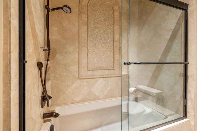 bathroom with shower / bath combination with glass door