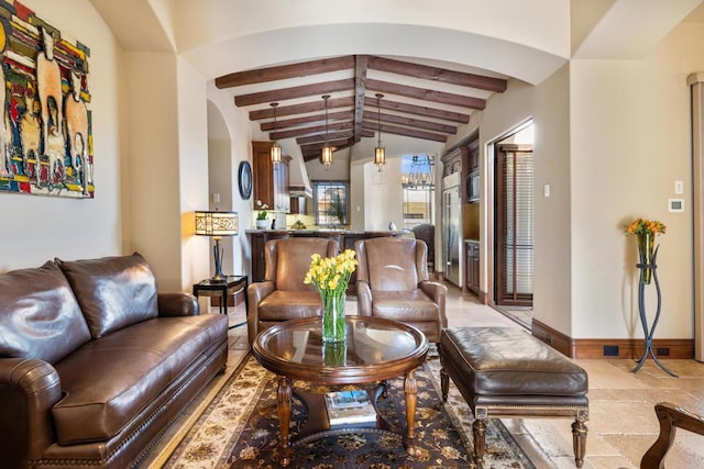 living room with vaulted ceiling with beams