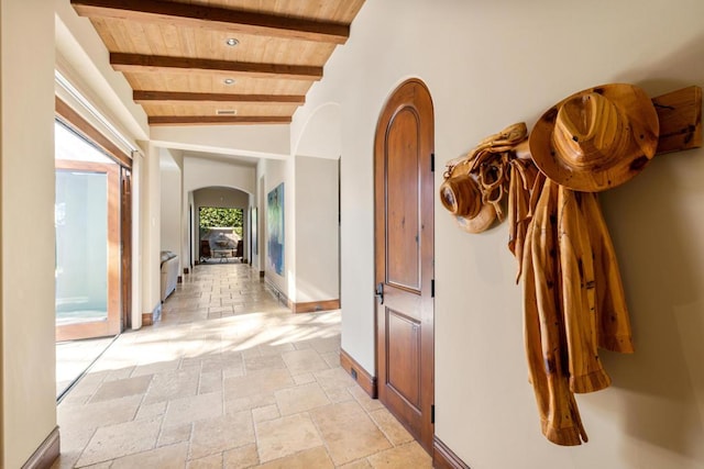 corridor featuring wooden ceiling and vaulted ceiling with beams