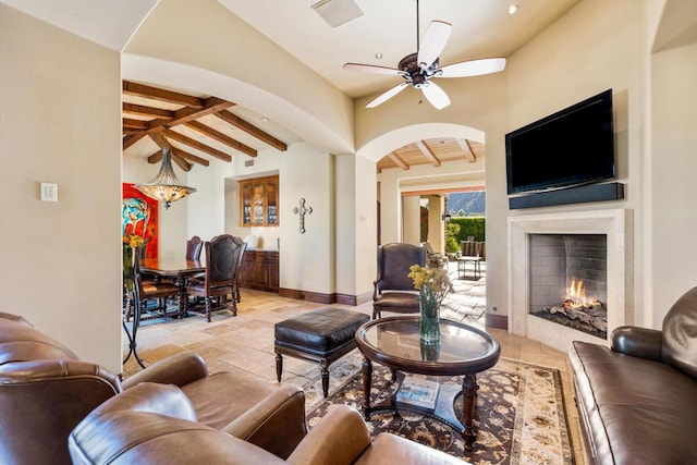 living room featuring beam ceiling and ceiling fan