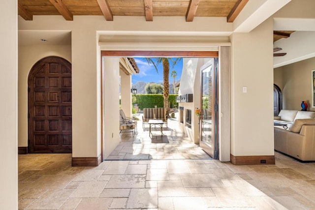 entryway with beam ceiling and wood ceiling