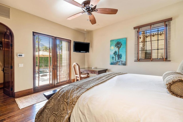 bedroom featuring ceiling fan, dark hardwood / wood-style flooring, and french doors