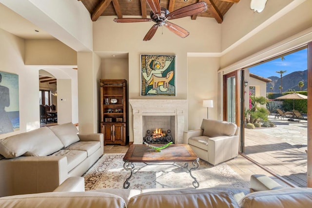 living room with high vaulted ceiling, beam ceiling, and wood ceiling