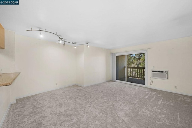 unfurnished room with carpet floors and a wall mounted air conditioner