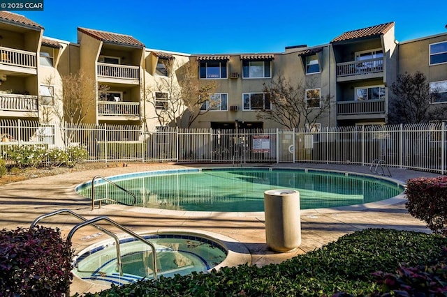 view of swimming pool featuring a community hot tub