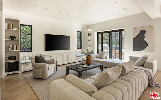 living room featuring a healthy amount of sunlight and parquet flooring