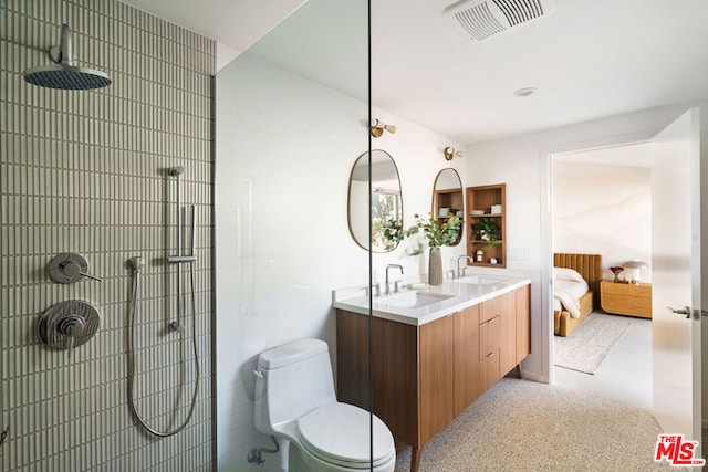 bathroom featuring toilet, vanity, and walk in shower