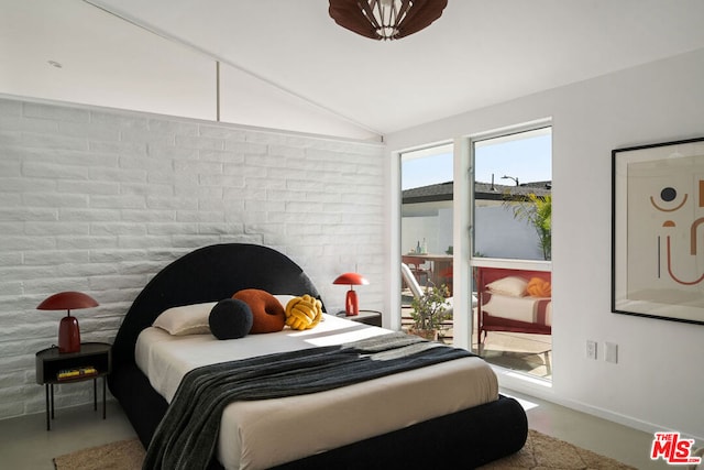 bedroom featuring concrete floors and vaulted ceiling