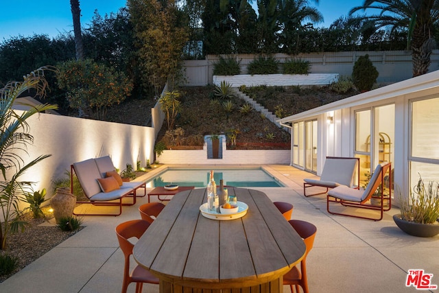 view of patio / terrace with a fenced in pool