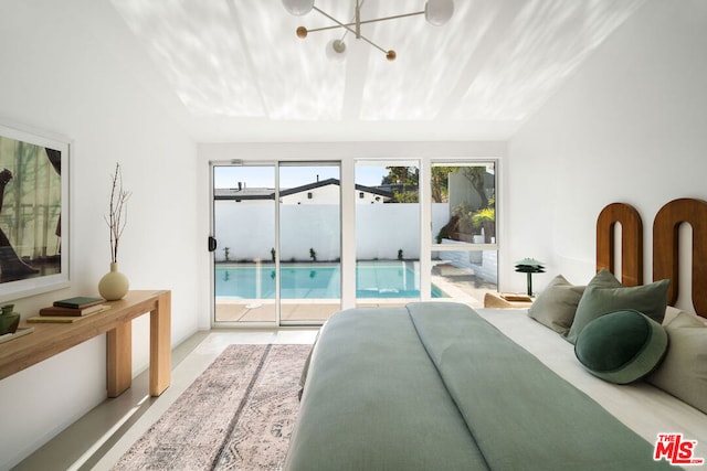 bedroom with lofted ceiling and access to outside