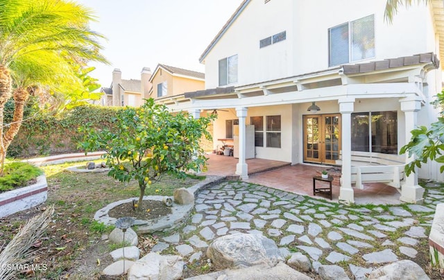 back of property with french doors and a patio area