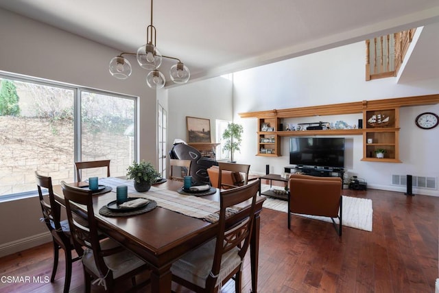 dining space featuring dark hardwood / wood-style floors and a chandelier