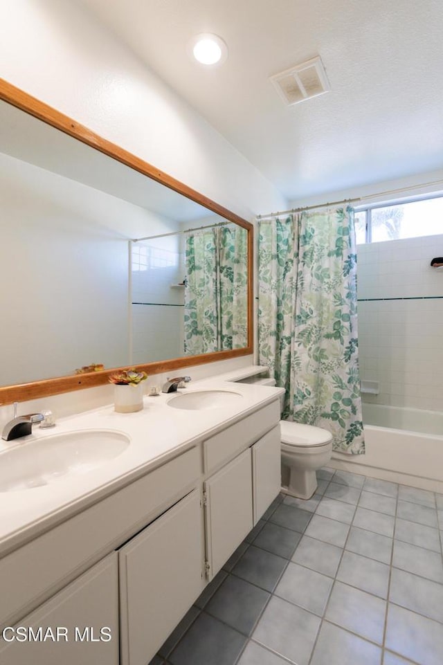 full bathroom with shower / bath combination with curtain, tile patterned floors, toilet, and vanity