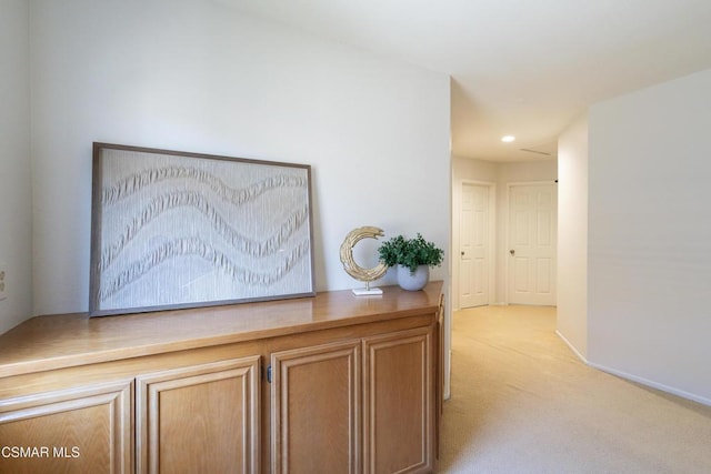 hallway featuring light colored carpet