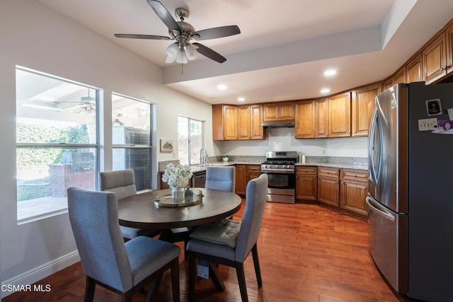 kitchen with hardwood / wood-style flooring, ceiling fan, and appliances with stainless steel finishes