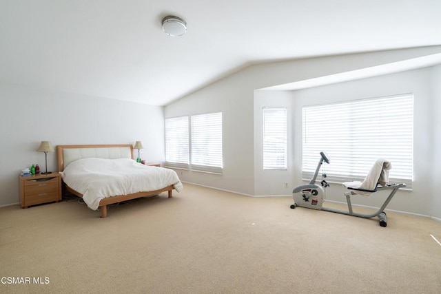 carpeted bedroom with lofted ceiling and multiple windows