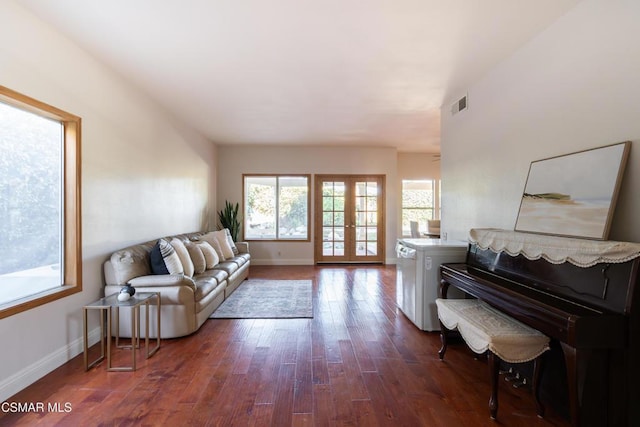 living room with dark hardwood / wood-style floors and french doors