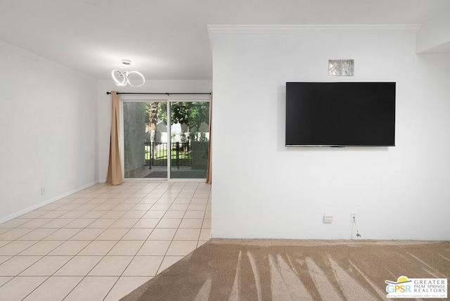 tiled spare room featuring crown molding