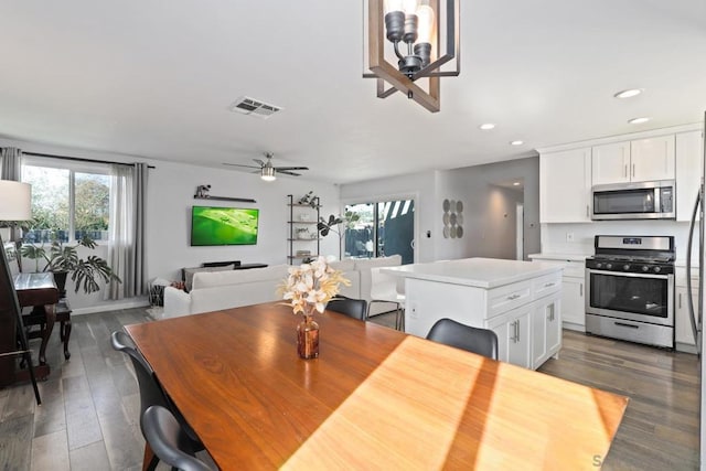 dining room with ceiling fan and dark hardwood / wood-style flooring