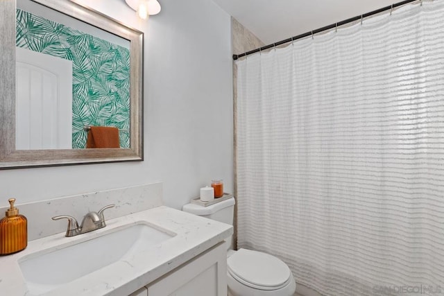 bathroom featuring toilet and vanity