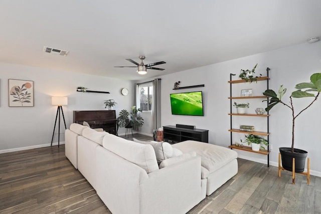 living room featuring ceiling fan and dark hardwood / wood-style floors